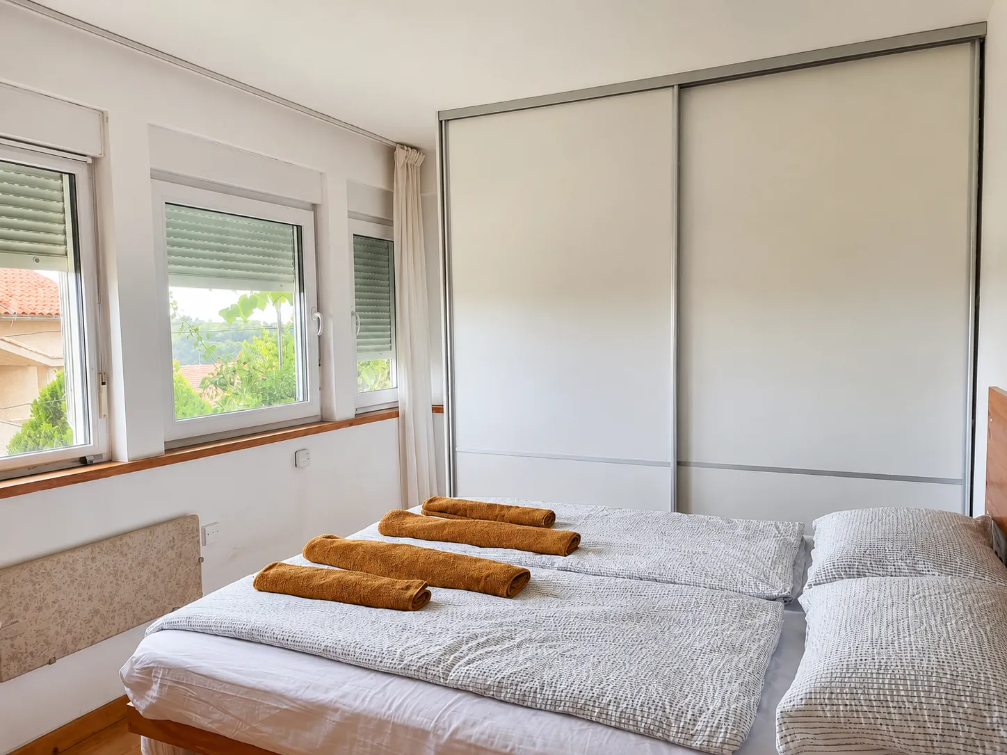 The bedroom, with a bright window view